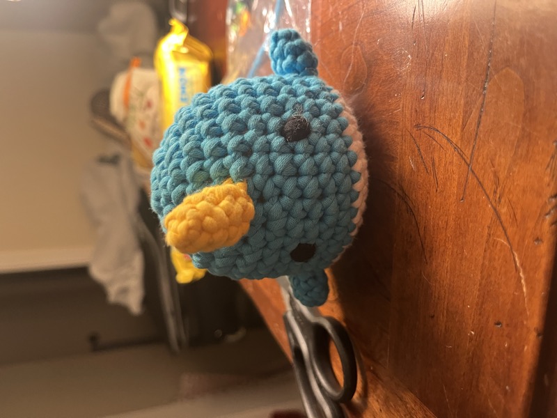 A crocheted Wooble narwhal